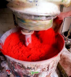 Mixing Michael Harding red pigment at the colour mill